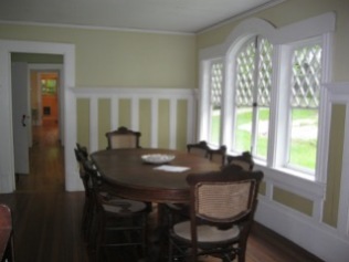 Anchorage, dining room table and view of west wing hallway all the way to the 3/4 bath at the end